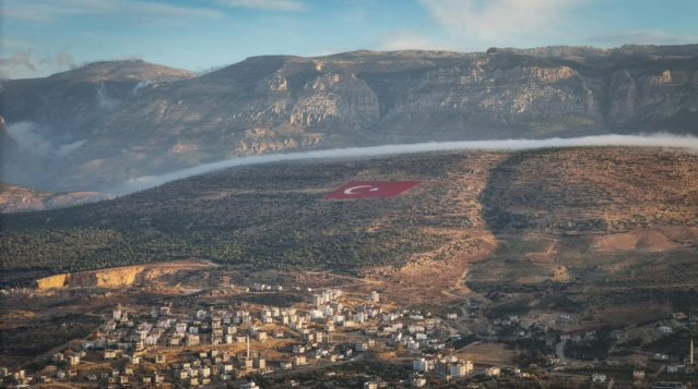 Duygusal Anlar
Özellikle sisin yoğun olduğu noktalarda bayrağın sadece üst kısımlarının görünmesi, ulusal sembolümüzün gücünü ve anlamını bir kez daha gözler önüne serdi. Vatandaşlar, bayrak ve sisin birleşimiyle oluşan bu manzarayı duygusal ve hayranlık uyandıran anlar olarak kaydetti.

Mut ilçesinin sembollerinden biri haline gelen bu dev bayrak, doğal güzelliklerle birleşince bölgenin tanıtımına da katkı sağlamaya devam ediyor.